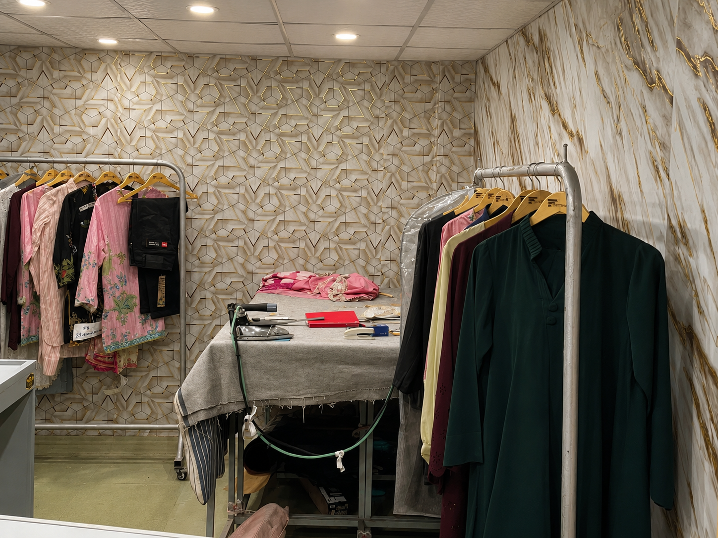 Finished garments hanging on racks in the sample room